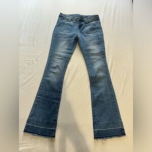 Low rise flare jeans with frayed hem and button fly